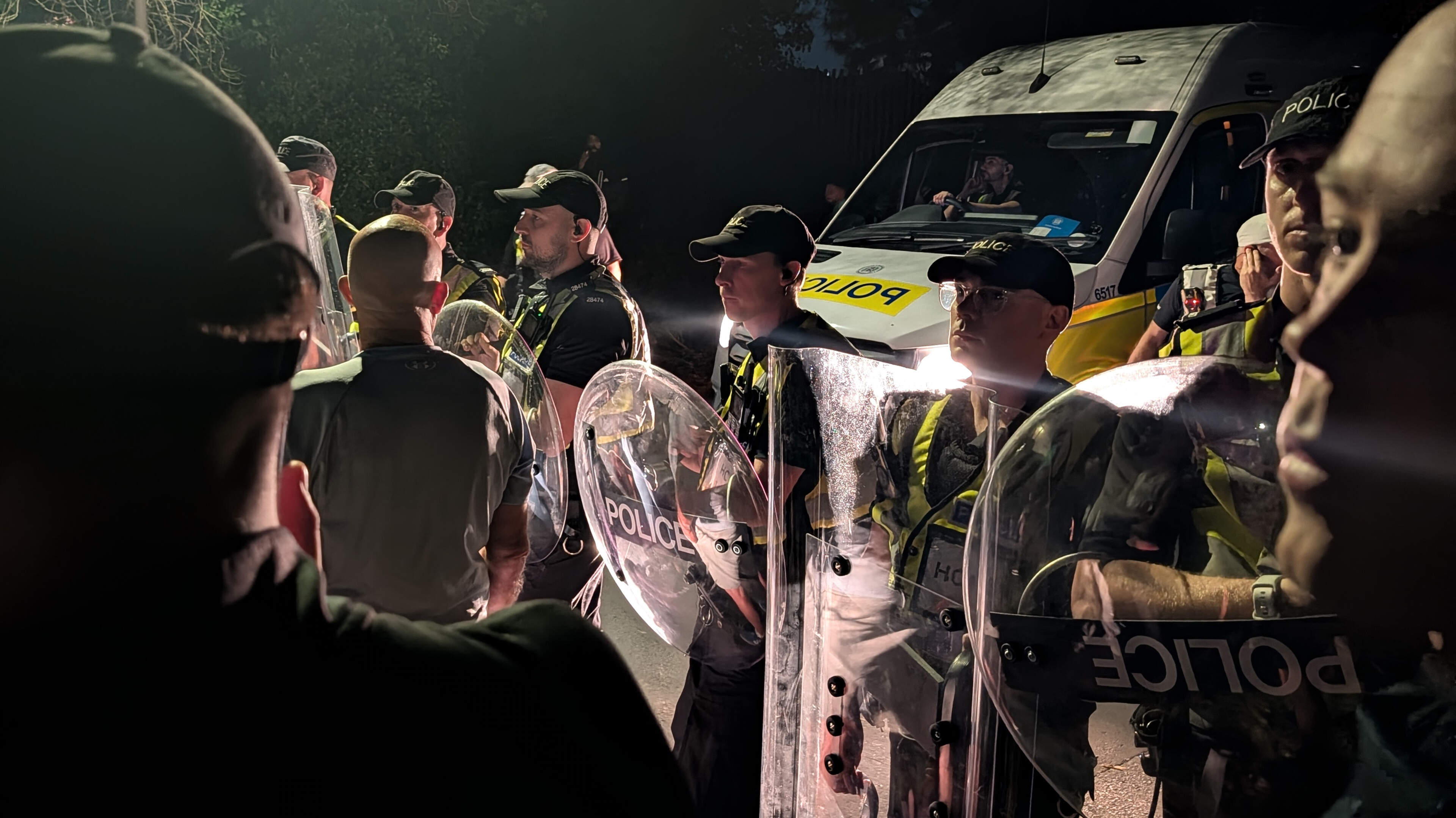 Hundreds of protesters in standoff with British police over migrant boat